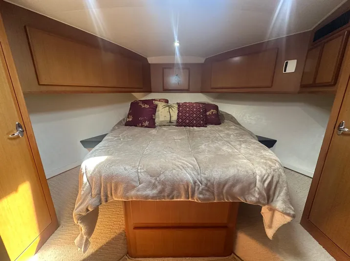 Current Addition Yacht Photos Pics Luxurious cabin interior of 2006 Henriques 42 Convertible yacht with cozy bedding.