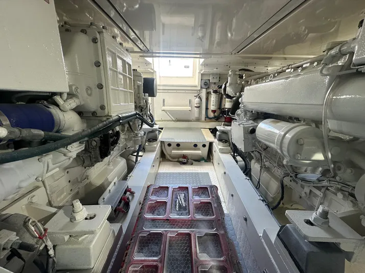 Current Addition Yacht Photos Pics Engine room of a 2006 Henriques 42 Convertible boat, showcasing dual engines and mechanical components.