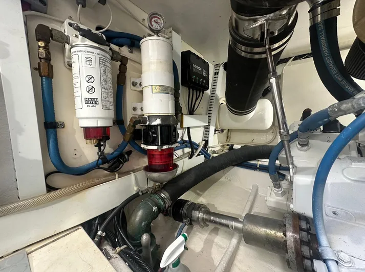 Current Addition Yacht Photos Pics Engine room of a 2006 Henriques 42 Convertible, featuring filters and hoses.
