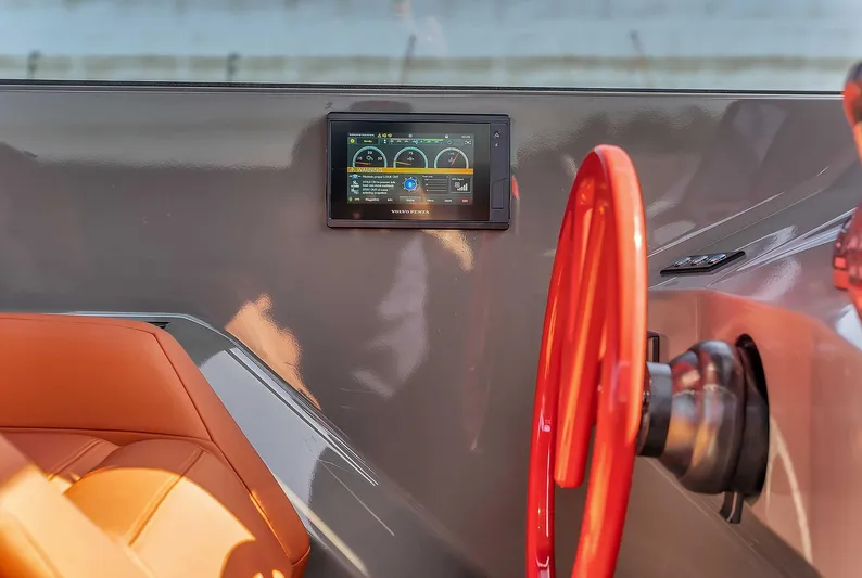 Spectra Yacht Photos Pics Interior of 2021 Vanquish Yachts VQ 45 with red steering wheel and digital display.