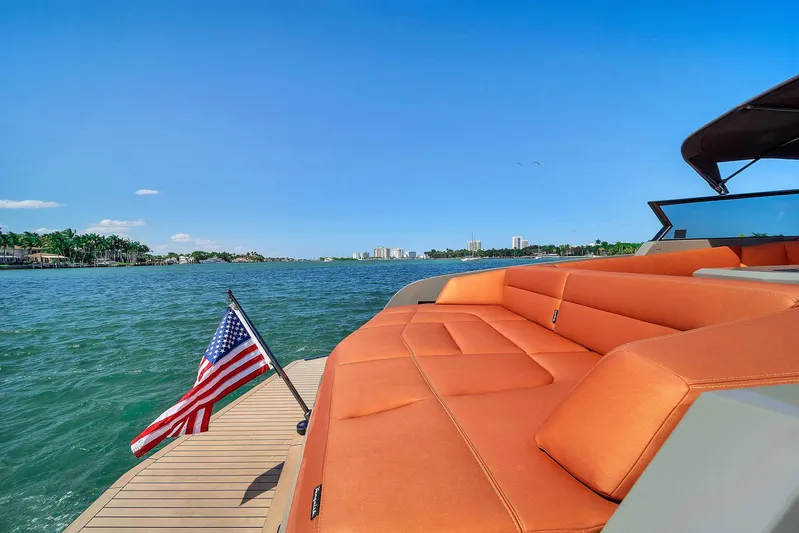 Spectra Yacht Photos Pics 2021 Vanquish Yachts VQ 45 with orange seating, American flag, and scenic water view.