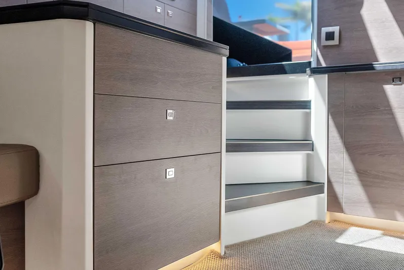 Spectra Yacht Photos Pics Interior of 2021 Vanquish Yachts VQ 45, featuring modern cabinetry and stairs.
