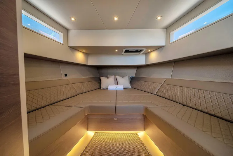 Spectra Yacht Photos Pics Luxurious interior of 2021 Vanquish Yachts VQ 45 with elegant seating and ambient lighting.