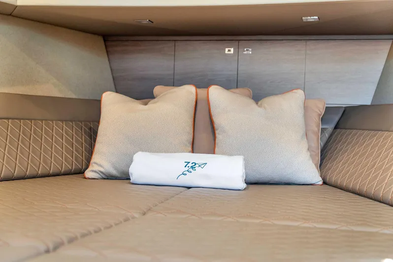 Spectra Yacht Photos Pics Luxurious interior of 2021 Vanquish Yachts VQ 45 with plush pillows and elegant bedding.