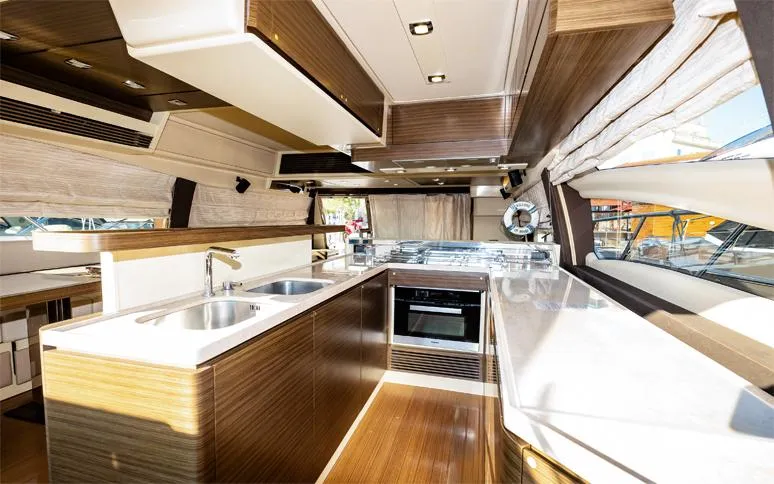  Yacht Photos Pics Luxurious 2014 Azimut 64 yacht kitchen with modern wood finishes and dual sinks.