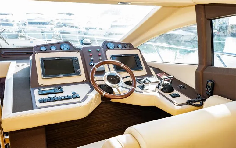  Yacht Photos Pics Luxurious 2014 Azimut 64 yacht helm with dual navigation screens and leather steering wheel.
