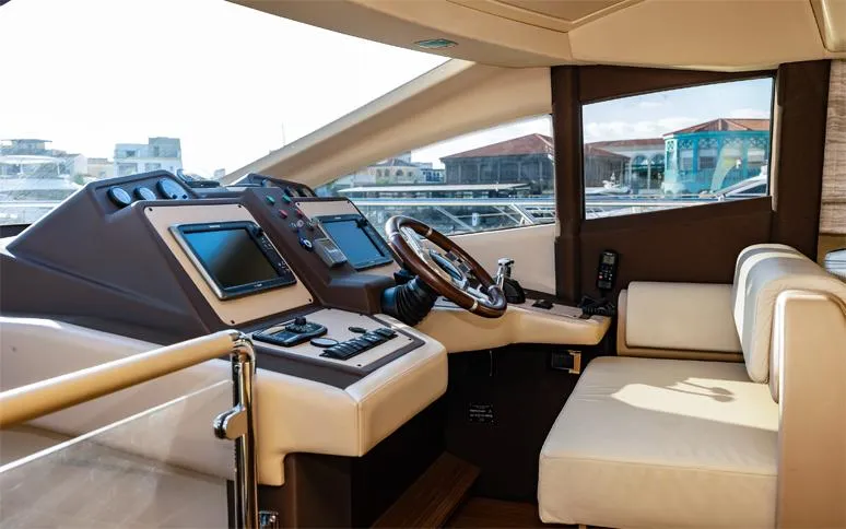  Yacht Photos Pics Luxurious 2014 Azimut 64 yacht interior with modern navigation controls and plush seating.
