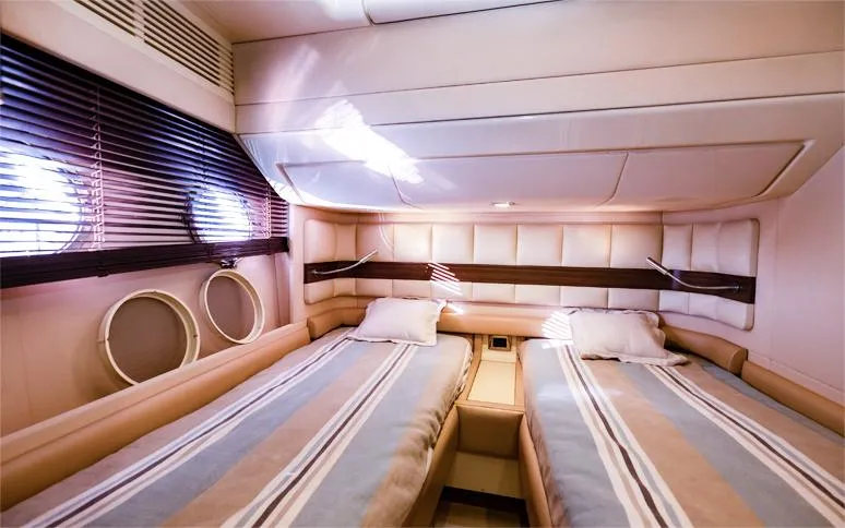  Yacht Photos Pics Luxurious twin cabin interior of 2014 Azimut 64 yacht with striped bedding.