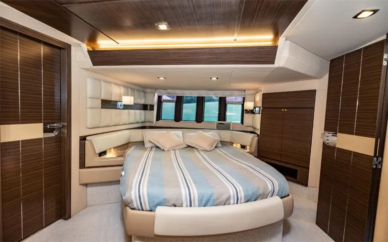  Yacht Photos Pics Luxurious bedroom interior of 2014 Azimut 64 yacht with modern design and striped bedding.
