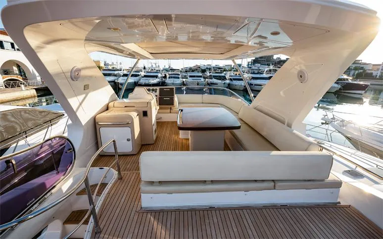  Yacht Photos Pics Luxurious 2014 Azimut 64 yacht deck with seating, table, and marina view.