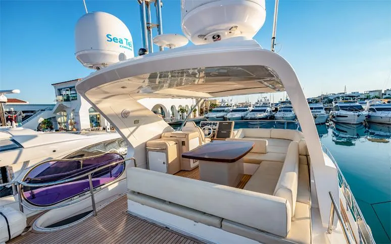  Yacht Photos Pics Luxurious 2014 Azimut 64 yacht with spacious outdoor seating at marina.
