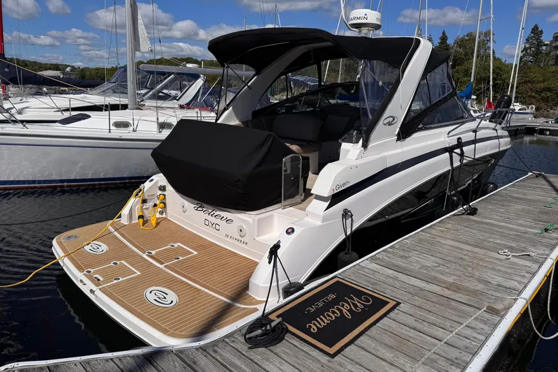  Yacht Photos Pics 2015 Regal 32 Express boat docked at marina under clear skies.