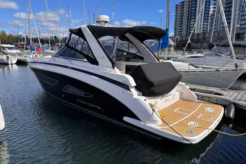  Yacht Photos Pics 2015 Regal 32 Express yacht docked at marina, surrounded by sailboats and buildings.