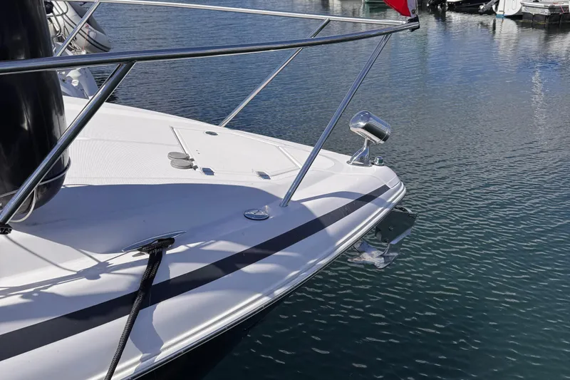  Yacht Photos Pics 2015 Regal 32 Express boat bow on calm water, featuring sleek design and chrome details.