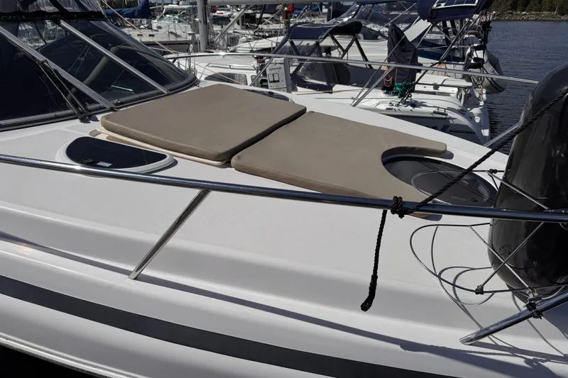  Yacht Photos Pics 2015 Regal 32 Express boat with sun pads on deck, docked in marina.