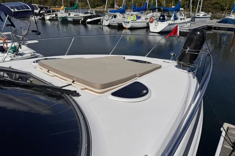  Yacht Photos Pics 2015 Regal 32 Express yacht docked, featuring a sun pad and sleek design.