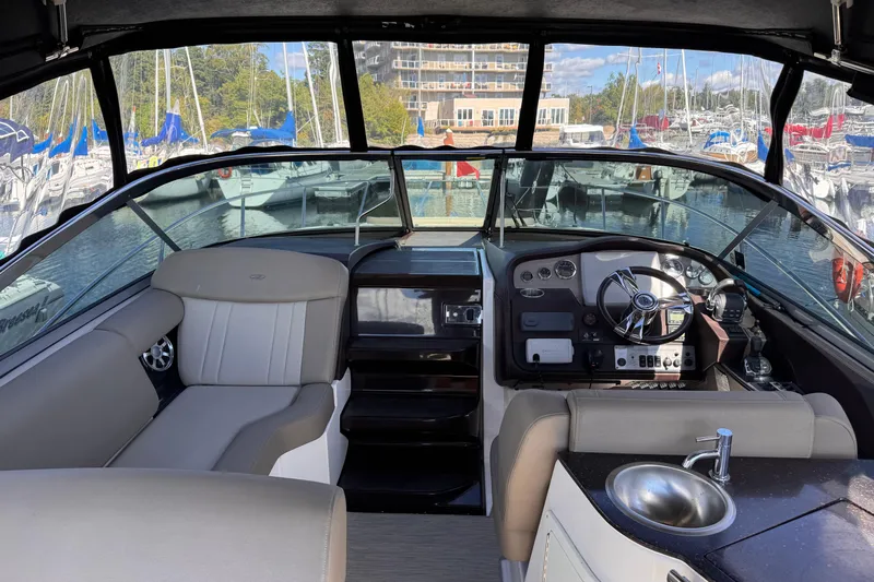  Yacht Photos Pics Interior of 2015 Regal 32 Express boat with helm, seating, and sink.