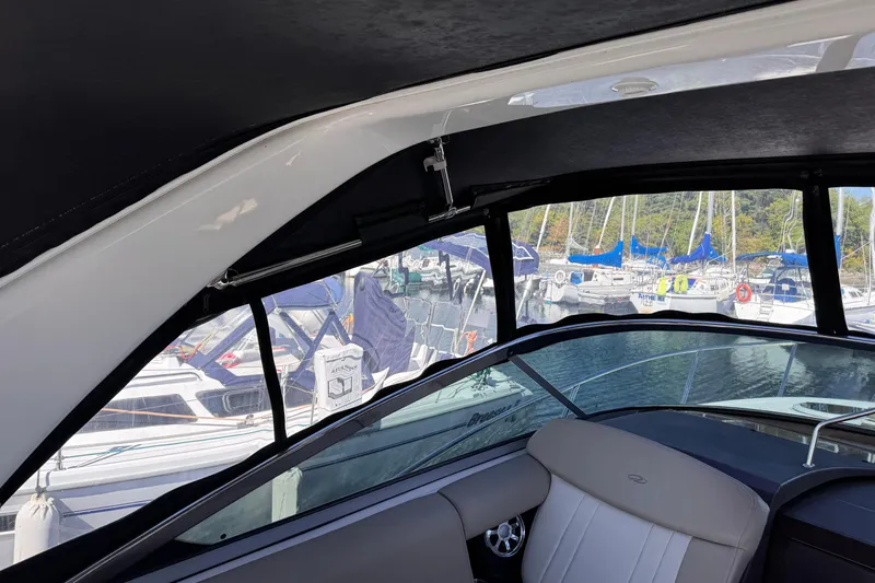  Yacht Photos Pics Interior view of 2015 Regal 32 Express boat with marina background.