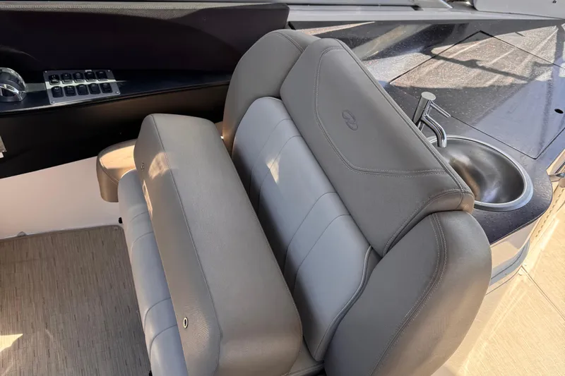  Yacht Photos Pics 2015 Regal 32 Express boat interior with gray seating and a small sink.