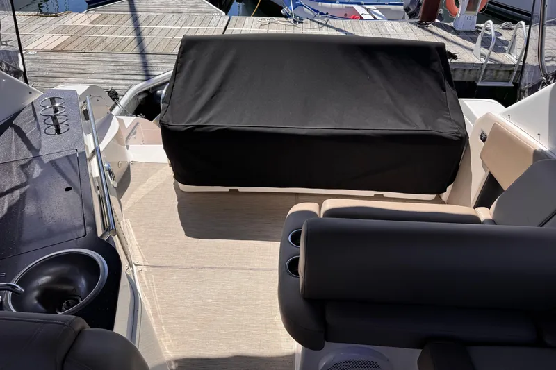  Yacht Photos Pics 2015 Regal 32 Express boat interior with seating and covered area at dock.