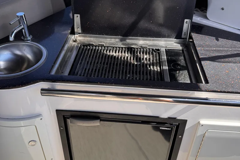  Yacht Photos Pics Outdoor kitchen on 2015 Regal 32 Express boat with grill and sink.