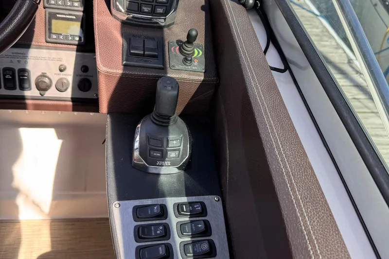  Yacht Photos Pics Control panel of a 2015 Regal 32 Express boat with joystick and buttons.