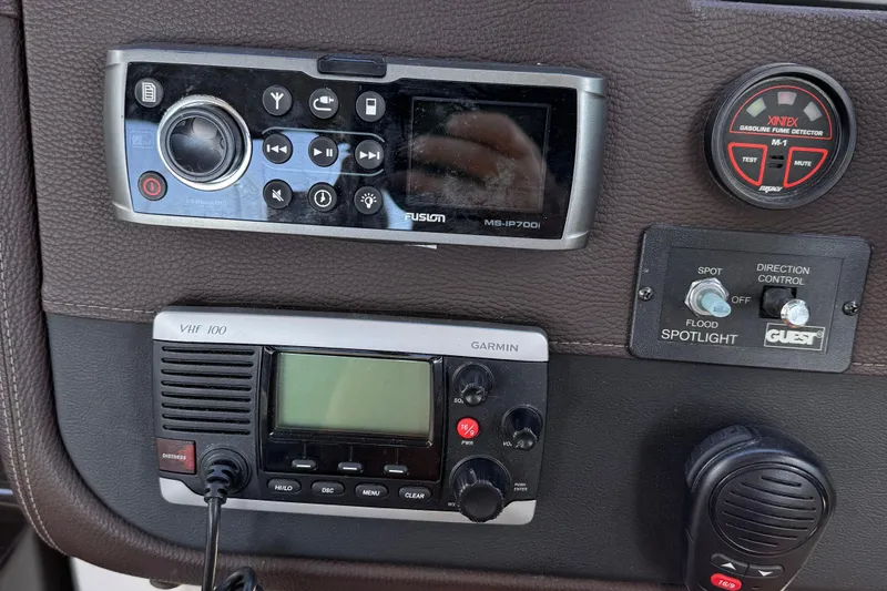  Yacht Photos Pics Control panel of a 2015 Regal 32 Express boat with radio and spotlight controls.