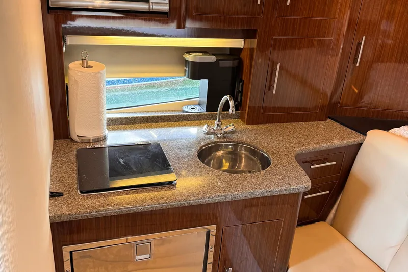  Yacht Photos Pics Luxurious 2015 Regal 32 Express yacht kitchen with granite countertop and modern amenities.