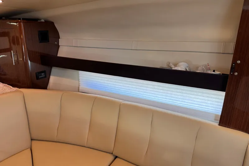  Yacht Photos Pics Interior of 2015 Regal 32 Express yacht with beige seating and wooden cabinetry.