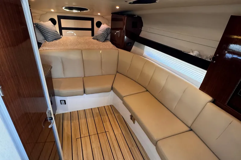  Yacht Photos Pics Luxurious interior of 2015 Regal 32 Express yacht with cozy seating and elegant wood flooring.