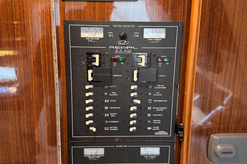 Yacht Photos Pics Electrical panel of a 2015 Regal 32 Express boat, featuring various switches and meters.