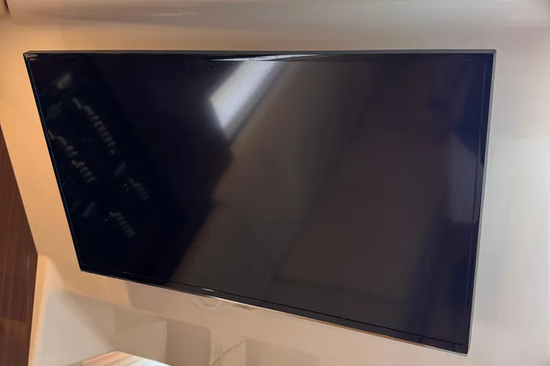  Yacht Photos Pics Wall-mounted flat-screen TV inside a 2015 Regal 32 Express boat.