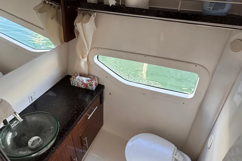  Yacht Photos Pics Bathroom interior of 2015 Regal 32 Express yacht with glass sink and window view.