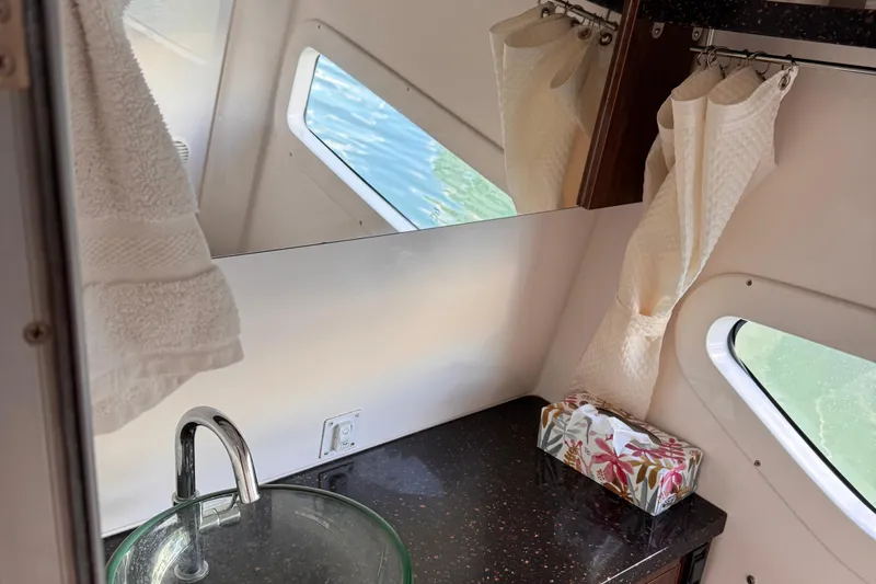  Yacht Photos Pics Interior of 2015 Regal 32 Express boat with sink, mirror, and window view.