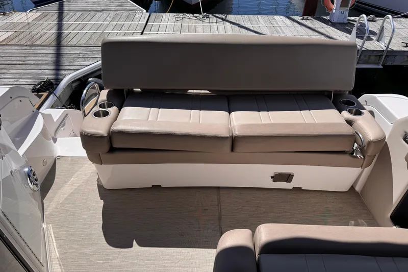  Yacht Photos Pics 2015 Regal 32 Express boat interior with beige seating and cup holders.