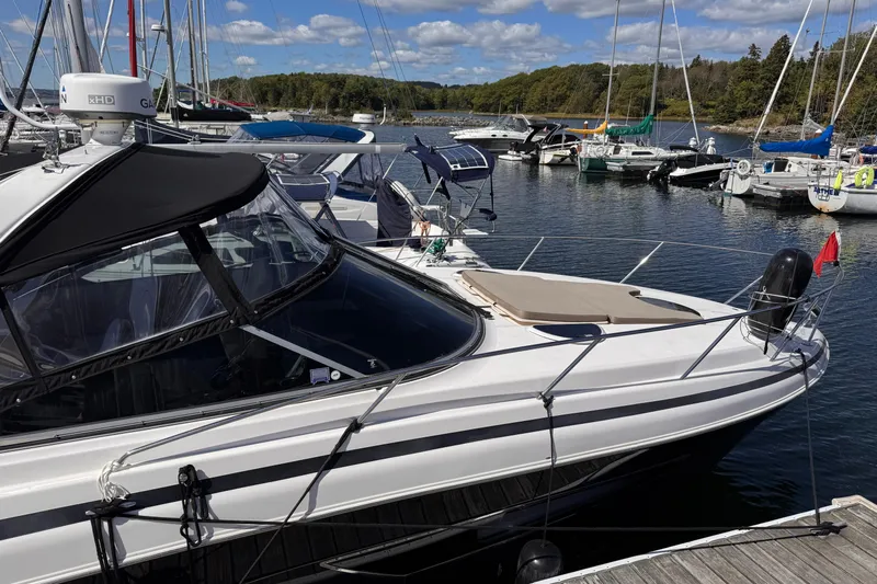  Yacht Photos Pics 2015 Regal 32 Express boat docked at a marina with sailboats in the background.