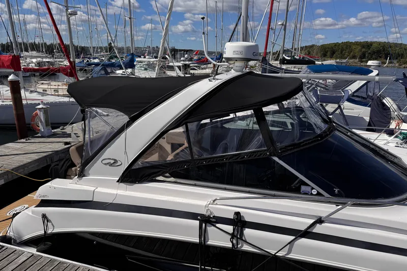  Yacht Photos Pics 2015 Regal 32 Express boat docked at marina with clear skies and sailboats.