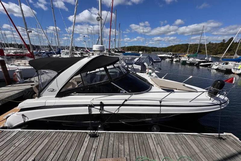 Yacht Photos Pics 2015 Regal 32 Express boat docked at marina under blue sky.