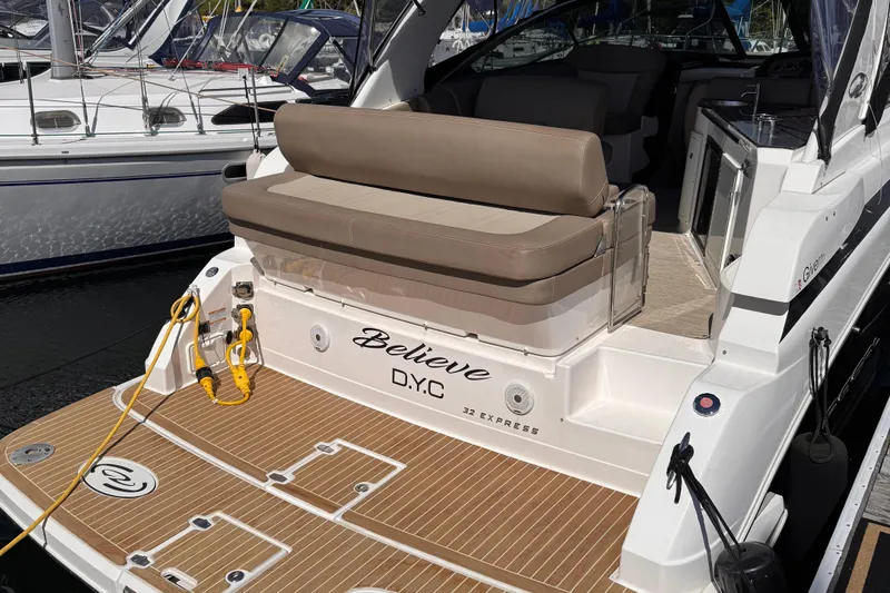  Yacht Photos Pics 2015 Regal 32 Express boat docked, featuring a spacious deck and comfortable seating.