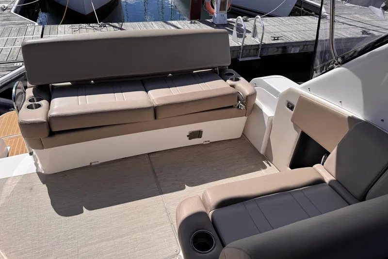  Yacht Photos Pics 2015 Regal 32 Express boat interior with beige seating and cup holders.