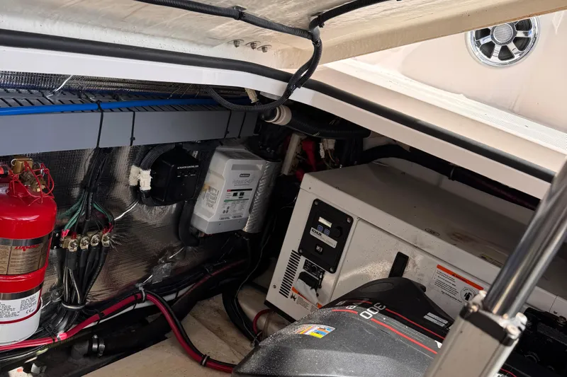  Yacht Photos Pics Engine compartment of a 2015 Regal 32 Express boat, featuring fire extinguisher and electrical components.