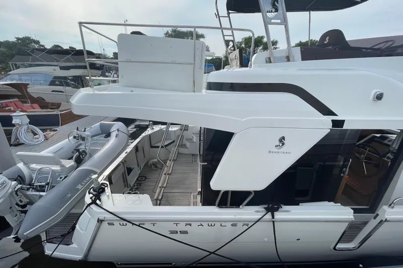 A To Z Yacht Photos Pics 2018 Beneteau Swift Trawler 35 docked, featuring sleek design and spacious deck area.