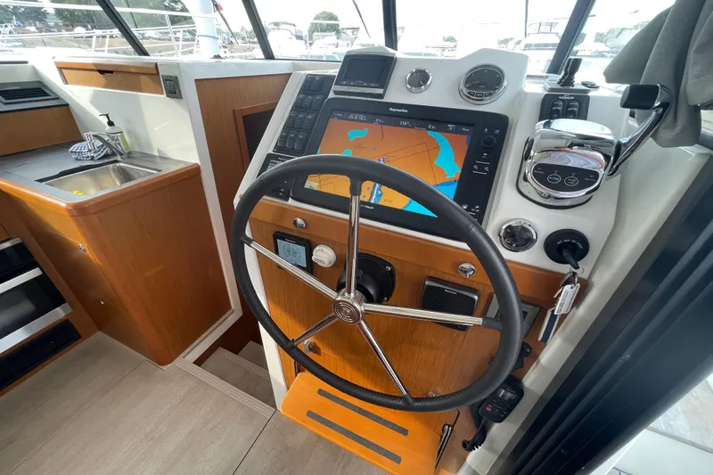 A To Z Yacht Photos Pics 2018 Beneteau Swift Trawler 35 helm with navigation display and steering wheel.