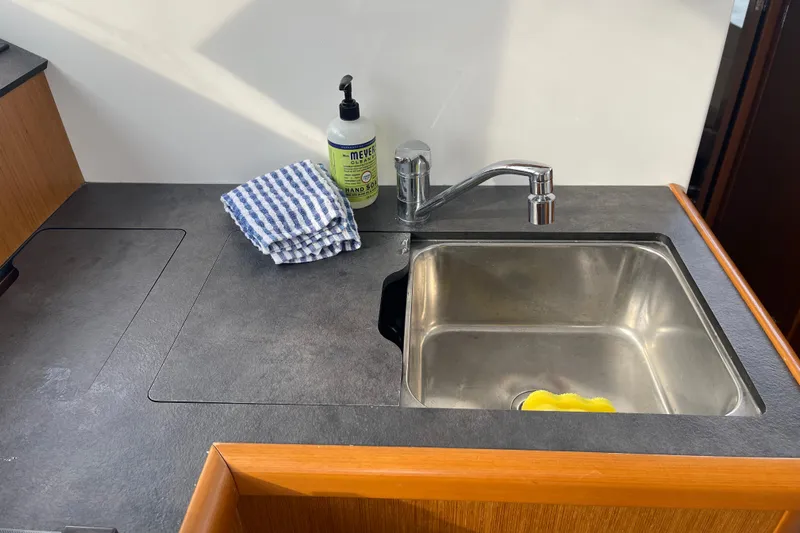 A To Z Yacht Photos Pics Kitchen sink area on 2018 Beneteau Swift Trawler 35 with hand soap and towel.