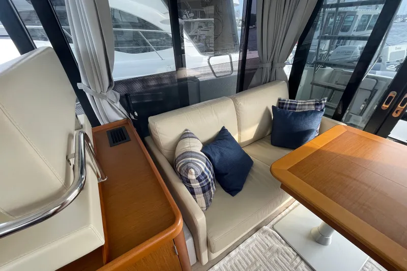 A To Z Yacht Photos Pics Interior of 2018 Beneteau Swift Trawler 35 with cozy seating and wooden table.