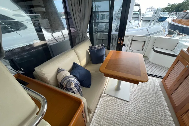 A To Z Yacht Photos Pics Interior of 2018 Beneteau Swift Trawler 35 with cozy seating and wooden table.