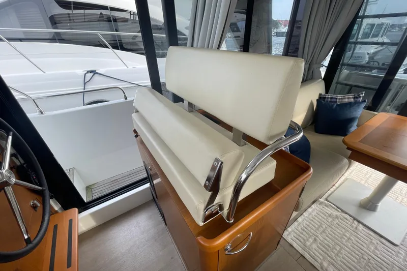A To Z Yacht Photos Pics Interior of 2018 Beneteau Swift Trawler 35, featuring helm seat and dining area.