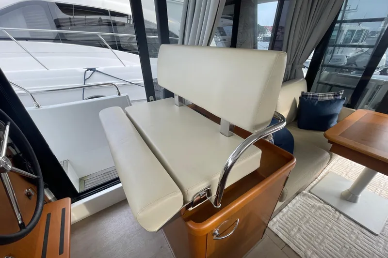 A To Z Yacht Photos Pics Interior of 2018 Beneteau Swift Trawler 35, featuring helm seat and dining area.