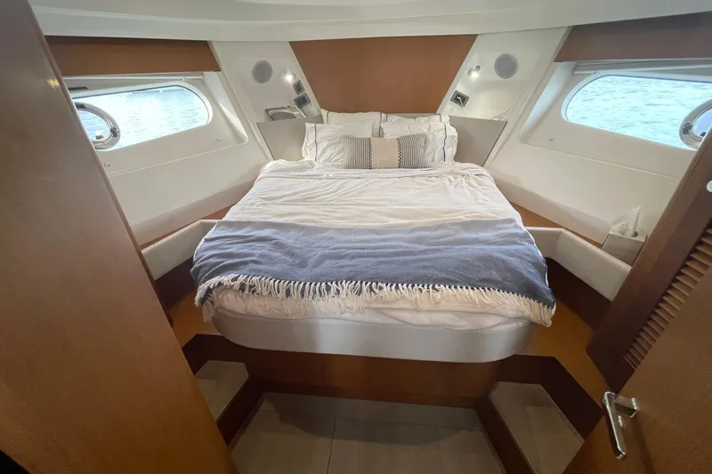 A To Z Yacht Photos Pics 2018 Beneteau Swift Trawler 35 cabin with cozy bed and nautical decor.