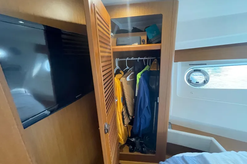 A To Z Yacht Photos Pics Interior of 2018 Beneteau Swift Trawler 35 with open closet and TV.